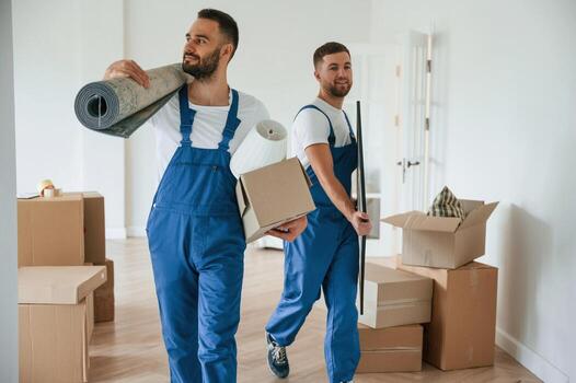 mat and painting in hands two moving service employees in a room photo